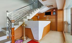 a staircase in a house with a stair case at Itsy By Treebo - Kottaram Residency in Ooty