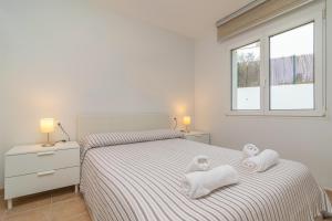 um quarto com duas toalhas numa cama em Edisol 29 -Villa Pilar 2- em Port d'Addaia