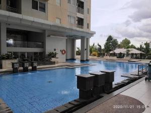 a large swimming pool in front of a building at Pakubuwono Terrace Apt,good location in Jakarta