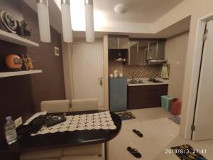 a kitchen and a dining room with a table and chairs at Pakubuwono Terrace Apt,good location in Jakarta