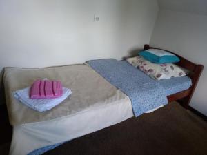 a bedroom with two beds with towels on them at Old Guest House 1964 in Žabljak