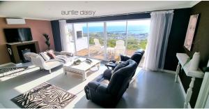 a living room with couches and a large window at The Lazy Daisies in St Helena Bay