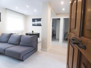 a living room with a couch and a table at Apartamento chile playa in Gijón