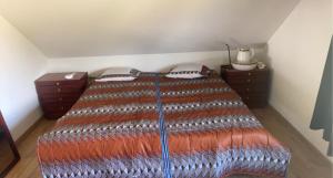 a bedroom with a bed with a large bedspread at STUDIO TOUT CONFORT in Soignies