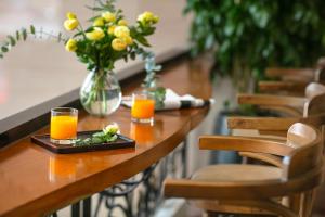 ホーチミン・シティにあるNesta Hotel Saigonのオレンジジュース2杯と花瓶 +94枚の写真