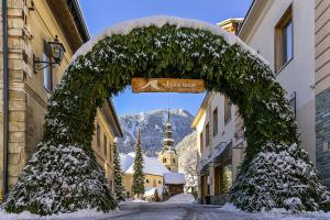 a arch in the middle of a street with a building at Apartma Studio Jana in Kranjska Gora
