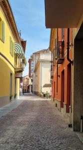 a cobblestone street in a town with colorful buildings at Rebel House Alba in Alba
