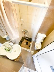 a bathroom with a white sink and a toilet at Gorica Guest House in Mavrovi Anovi