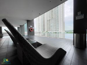 a empty room with chairs and a large building at VSummer Stylish Loft Suites @ UHA in Johor Bahru