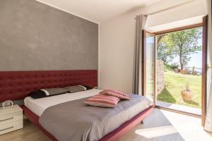 a bedroom with a bed with a red headboard and a window at Malga Mary in Tignale +60 photos
