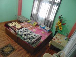 a small bedroom with a bed and a window at BOJO house in Gangtok