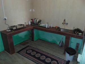 a kitchen with a wooden counter with a sink at BOJO house in Gangtok