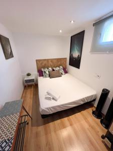 a bedroom with a large white bed in a room at La Residencia de Espiritu Santo in Madrid