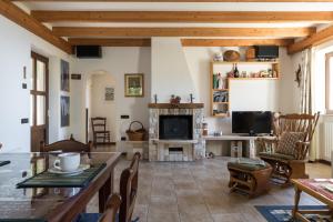 a living room with a fireplace and a table at Malga Mary in Tignale