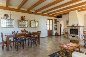 a living room with a table and chairs and a fireplace at Malga Mary in Tignale