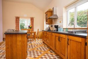 a kitchen with wooden cabinets and a counter top at Church Island View Holiday Home in Waterville