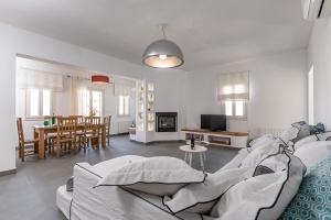 a living room with a couch and a dining room at Orkos Beach Hotel in Mikri Vigla