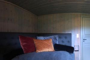 uma cama com almofadas em cima num quarto em Seterhytte i Havsdalen em Geilo