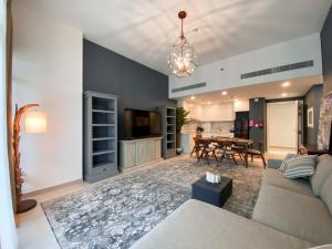 a living room with a couch and a table at Dar Vacation - Blue Spacious Luxury Apartment in Dubai