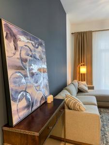 a living room with a couch and a painting on the wall at Dar Vacation - Blue Spacious Luxury Apartment in Dubai