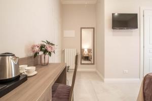 a kitchen with a counter with a vase of flowers at DANY GUEST HOUSE in Rome