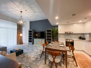 a kitchen and living room with a table and chairs at Dar Vacation - Blue Spacious Luxury Apartment in Dubai