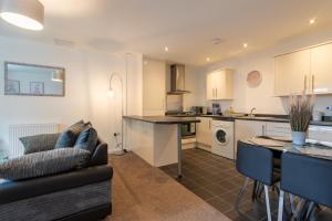 a kitchen and living room with a couch and a table at No 14 in Mansfield