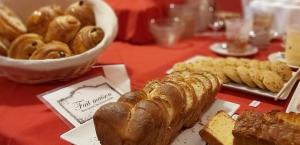 a table topped with bread and pastries on a table at Hôtel du Palais in Angoulême