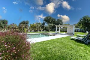 a backyard with a pool and a gazebo at ALMASOL - Charme Experience in Castellana Grotte