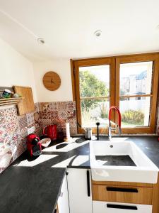 a kitchen with a white sink and a window at Villa Sainte Claire in Saint Malo