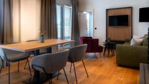 a living room with a table and chairs at Burgau Hotel Sonnenhof in Burgau