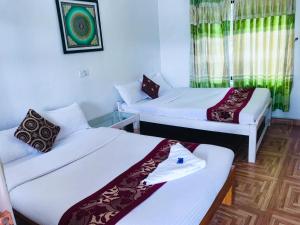 Voodi või voodid majutusasutuse Hotel Buddha Land toas