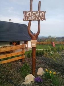 a sign for a library in front of a building at Chalupa U kapličky 