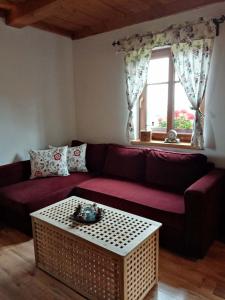 a living room with a red couch and a window at Chalupa U kapličky 