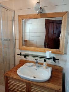 a bathroom with a sink and a mirror at Chalupa U kapličky 