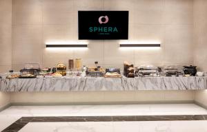 a buffet of food on a counter in a restaurant at Sphera by Stellar Hotels, Yerevan in Yerevan