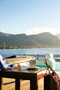 a wooden table with a surfboard on top of it at Harbour House Hotel in Hermanus