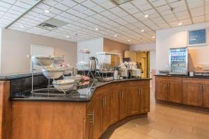 a kitchen with a counter with many dishes on it at Comfort Suites Downtown in Montreal