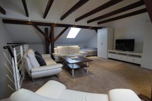 a living room with white furniture and a flat screen tv at Gemütliche Unterkunft für bis zu 11 Personen. in Hannover