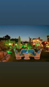 a group of chairs and a table with an umbrella at White Country Boutique Hotel in Antalya