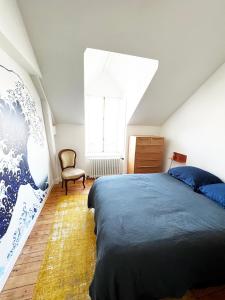 a bedroom with a large bed and a window at Villa Sainte Claire in Saint Malo