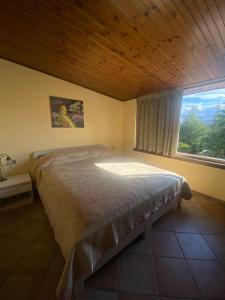 a bedroom with a large bed with a window at Villa Castello Andria in Castel del Monte