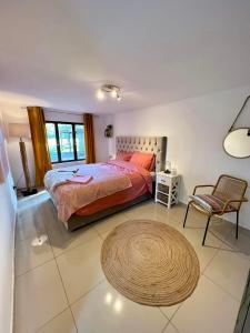 a bedroom with a bed and a chair and a rug at The Cottage in Bocholt