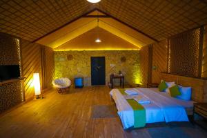 a bedroom with a large bed in a room at SAMA Ras Al Jinz Resort in Sur