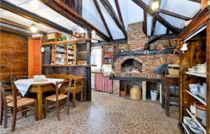 a dining room with a table and a fireplace at Beautiful Home In Breznica With Kitchen in Brežnica