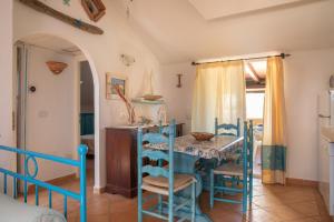 a dining room with a blue table and chairs at Casa Gallo in Santa Marinella