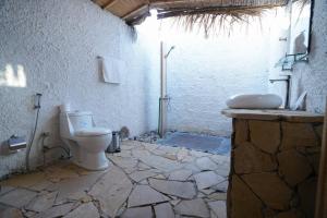 a bathroom with a toilet and a sink at SAMA Ras Al Jinz Resort in Sur