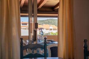 a dining room table with a view out a window at Casa Gallo in Santa Marinella