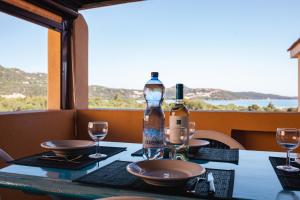 a table with a bottle of wine and glasses on it at Casa Gallo in Santa Marinella