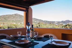 a table with a bottle of wine and glasses on it at Casa Gallo in Santa Marinella
